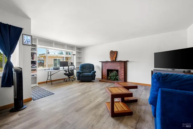 a living room with furniture flat screen tv and a fireplace