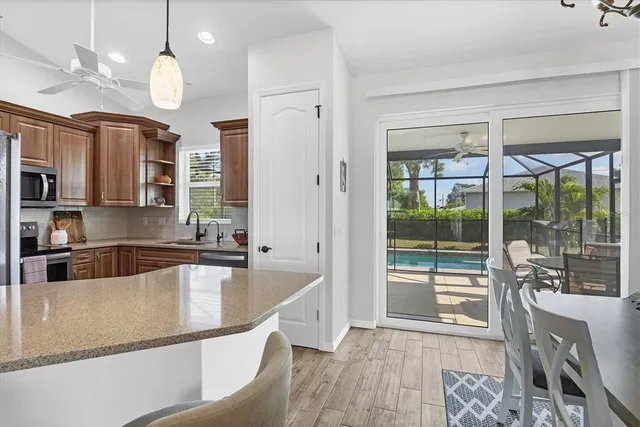 a kitchen with stainless steel appliances granite countertop a sink a stove and a refrigerator