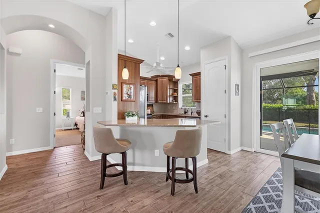 a dining room with furniture and wooden floor