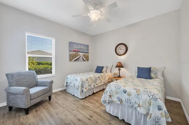 a bedroom with two beds and a couch