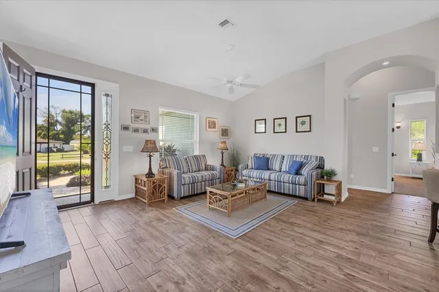 a living room with furniture and wooden floor