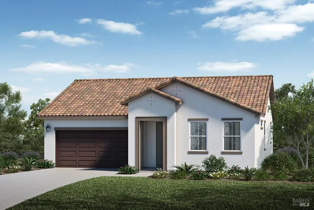 a front view of a house with a garden and yard