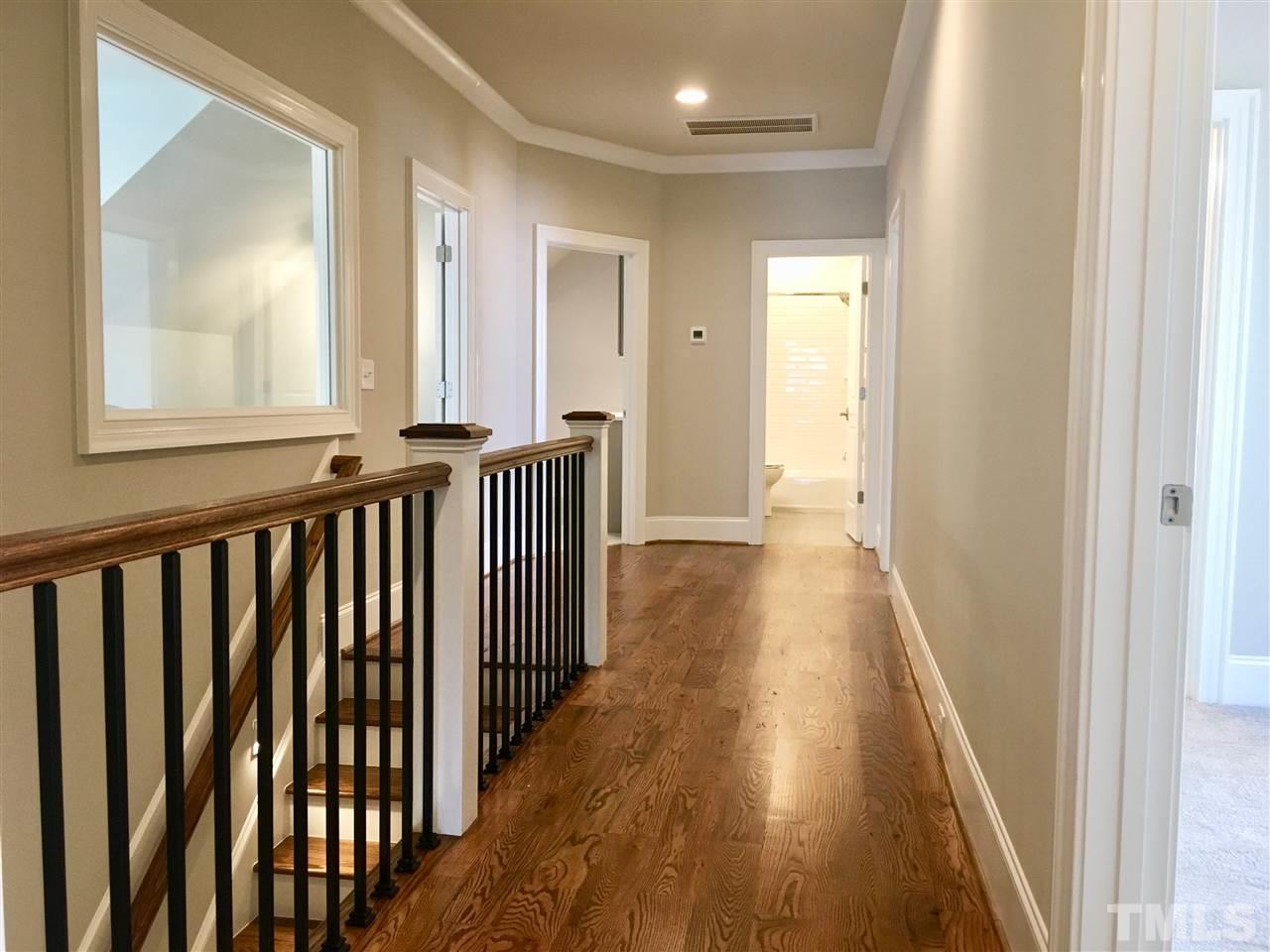 1501 Nottingham Road Raleigh, NC 27607 - Photo 18 of 25 a view of a hallway with wooden floor and stairs