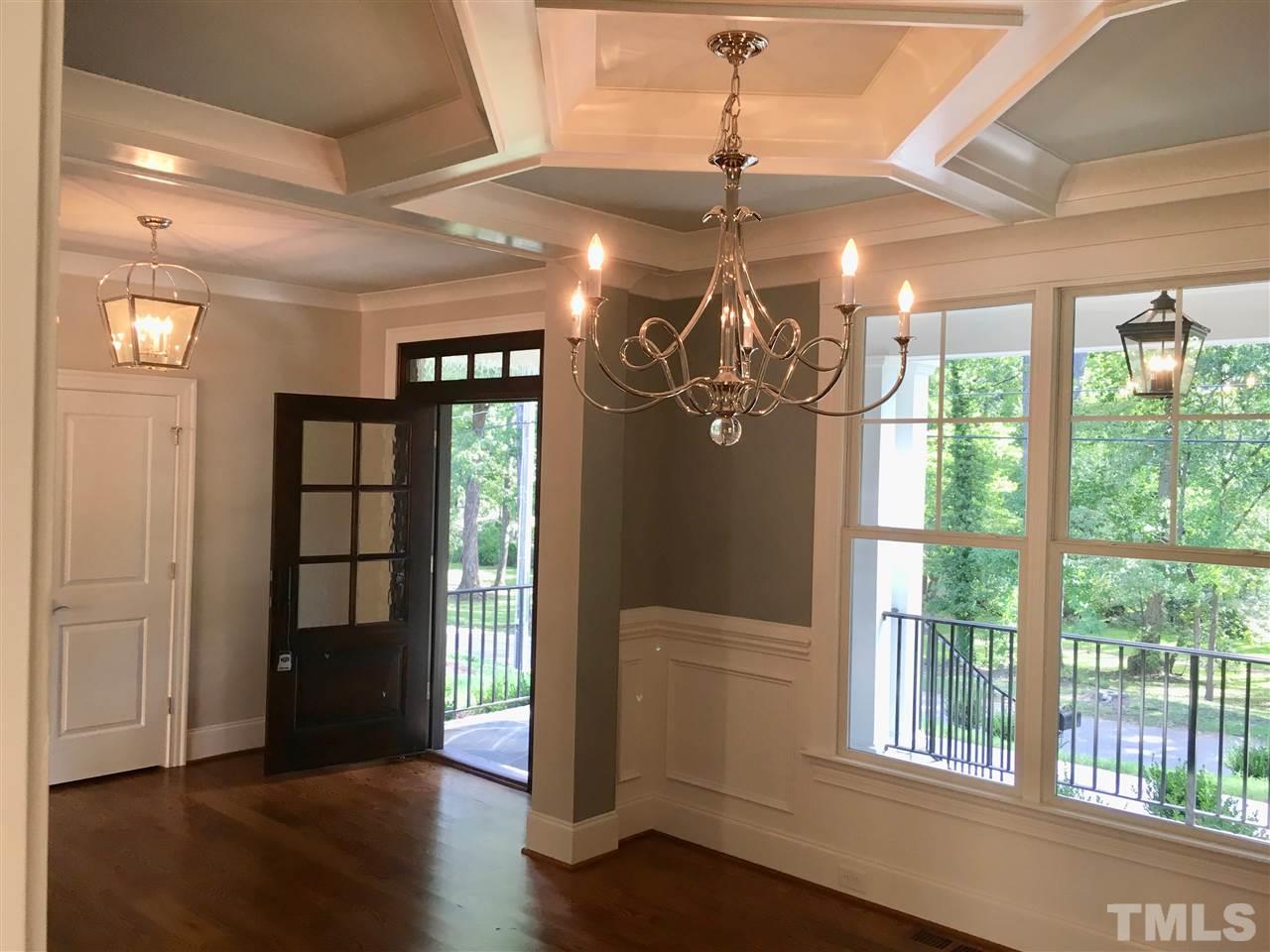 1501 Nottingham Road Raleigh, NC 27607 - Photo 3 of 25 a view of a livingroom with wooden floor and chandelier