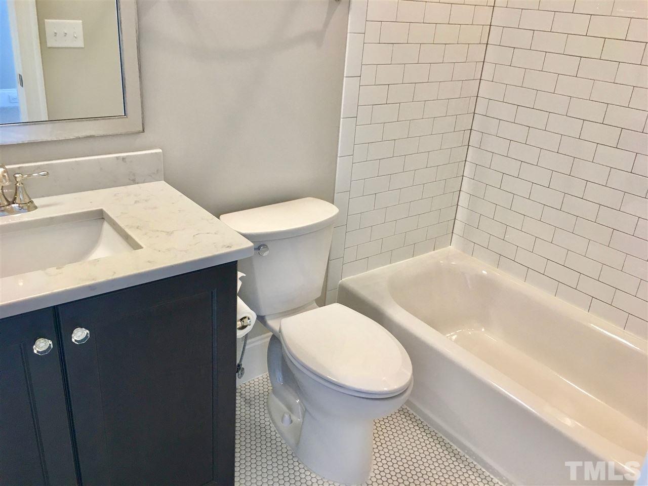 1501 Nottingham Road Raleigh, NC 27607 - Photo 23 of 25 a bathroom with a sink a toilet and shower