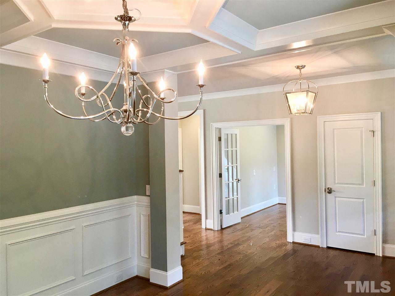 1501 Nottingham Road Raleigh, NC 27607 - Photo 5 of 25 a view of a hallway with chandelier and wooden floor