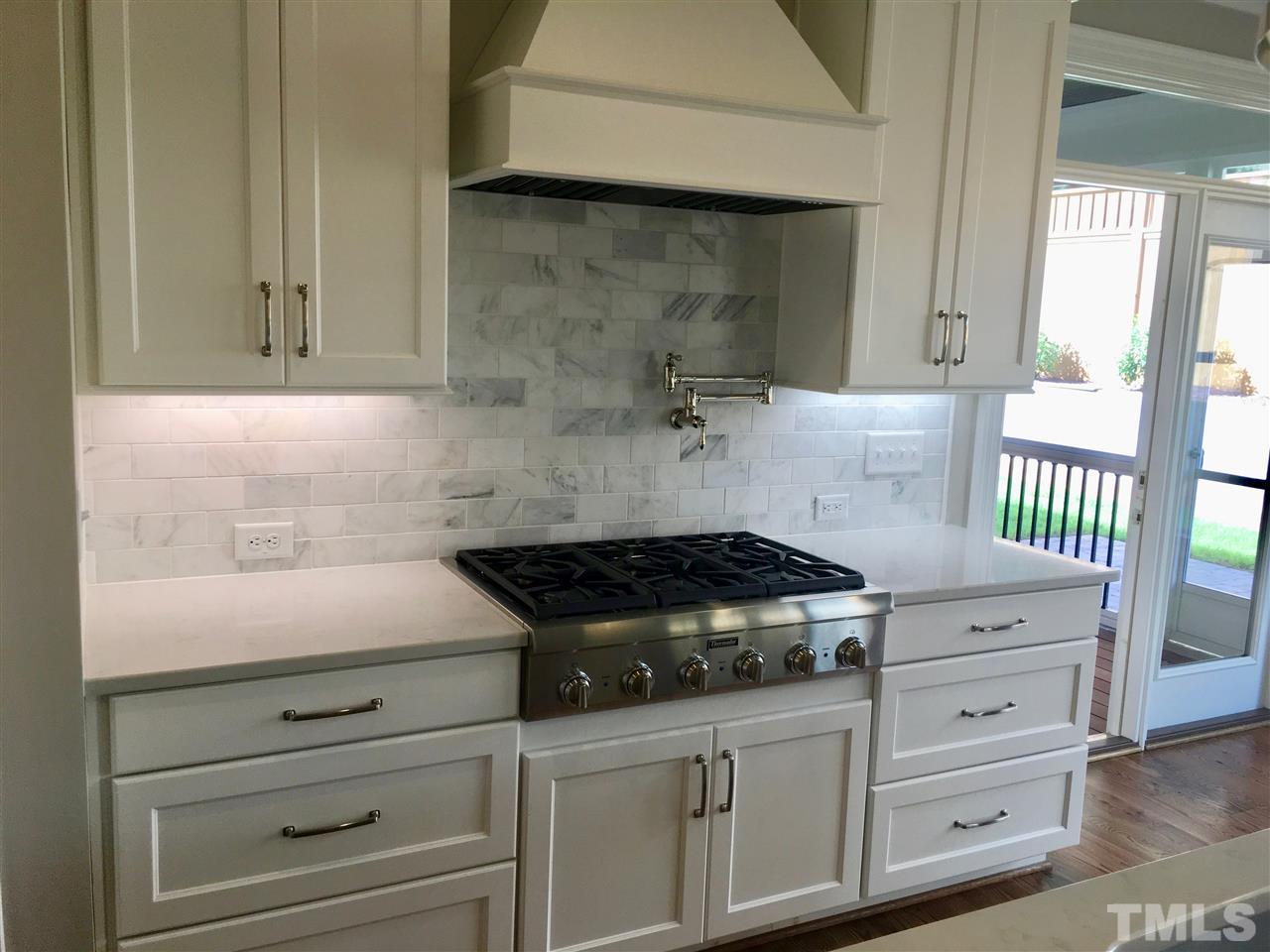 1501 Nottingham Road Raleigh, NC 27607 - Photo 9 of 25 a kitchen with granite countertop white cabinets and white appliances