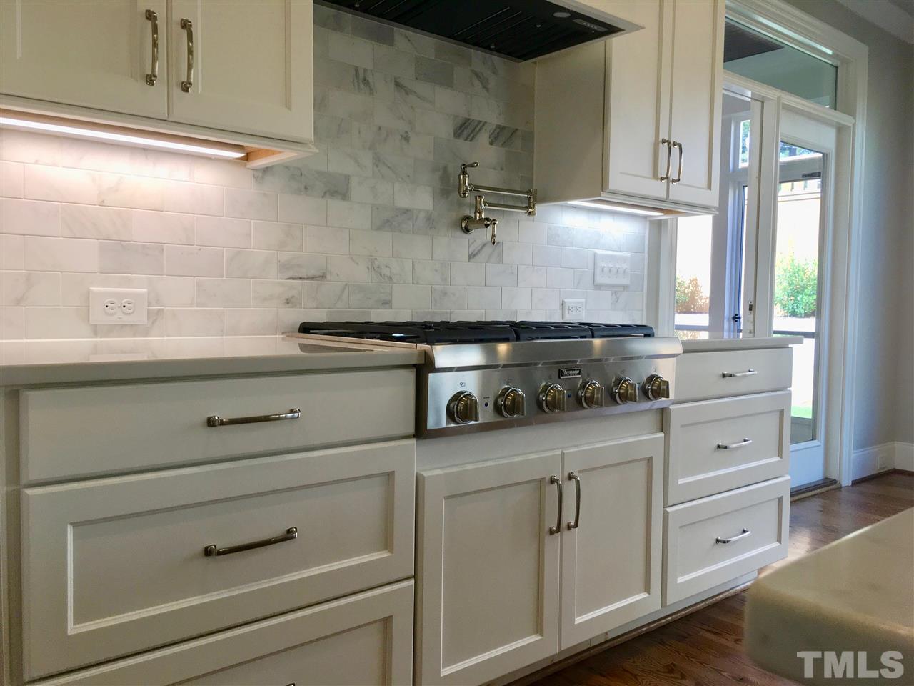 1501 Nottingham Road Raleigh, NC 27607 - Photo 10 of 25 a kitchen with white cabinets and white appliances