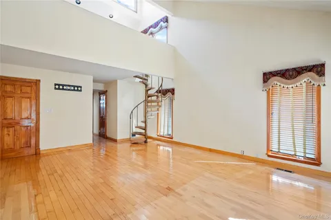 a spacious bathroom with a tub sink and mirror