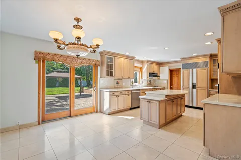 a kitchen with stainless steel appliances granite countertop a sink and dishwasher a stove top oven with wooden floor