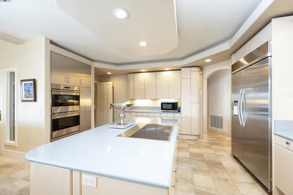 a kitchen with stainless steel appliances granite countertop a refrigerator and a sink