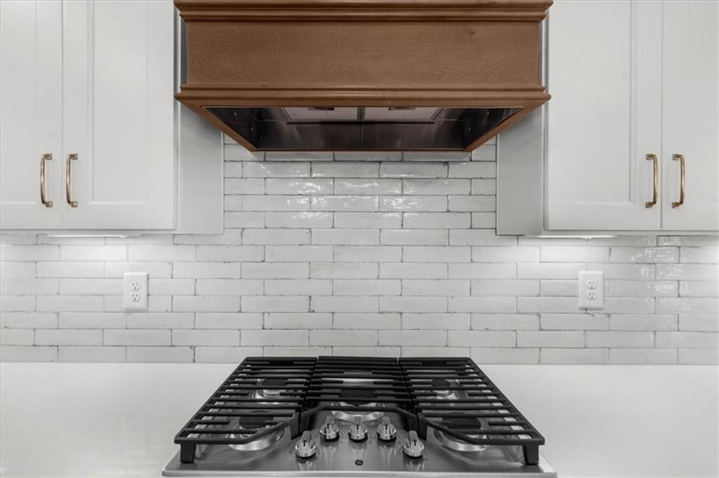 504 Level Creek Road Sugar Hill, GA 30518 - Photo 11 of 54 a close view of a stove a microwave and cabinets