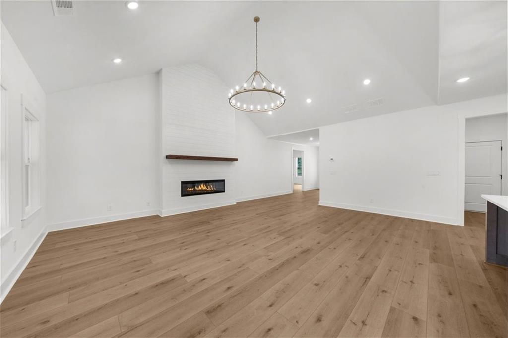 504 Level Creek Road Sugar Hill, GA 30518 - Photo 19 of 54 a view of an empty room with wooden floor and a window