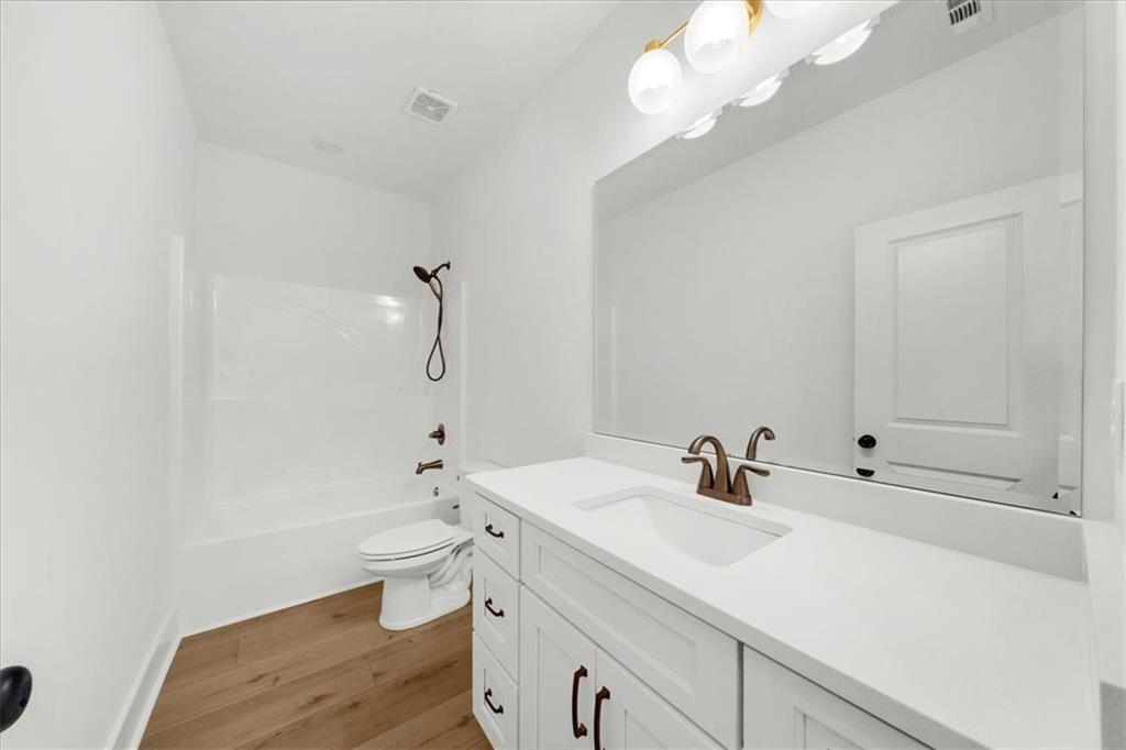 504 Level Creek Road Sugar Hill, GA 30518 - Photo 22 of 54 a bathroom with a sink a toilet and shower