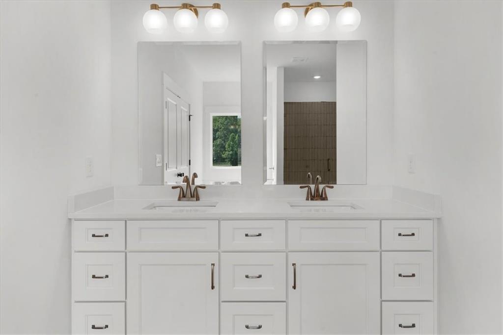 504 Level Creek Road Sugar Hill, GA 30518 - Photo 27 of 54 a bathroom with a sink and a mirror
