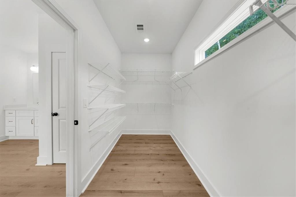 504 Level Creek Road Sugar Hill, GA 30518 - Photo 29 of 54 a view of a hallway with wooden floor and cabinet