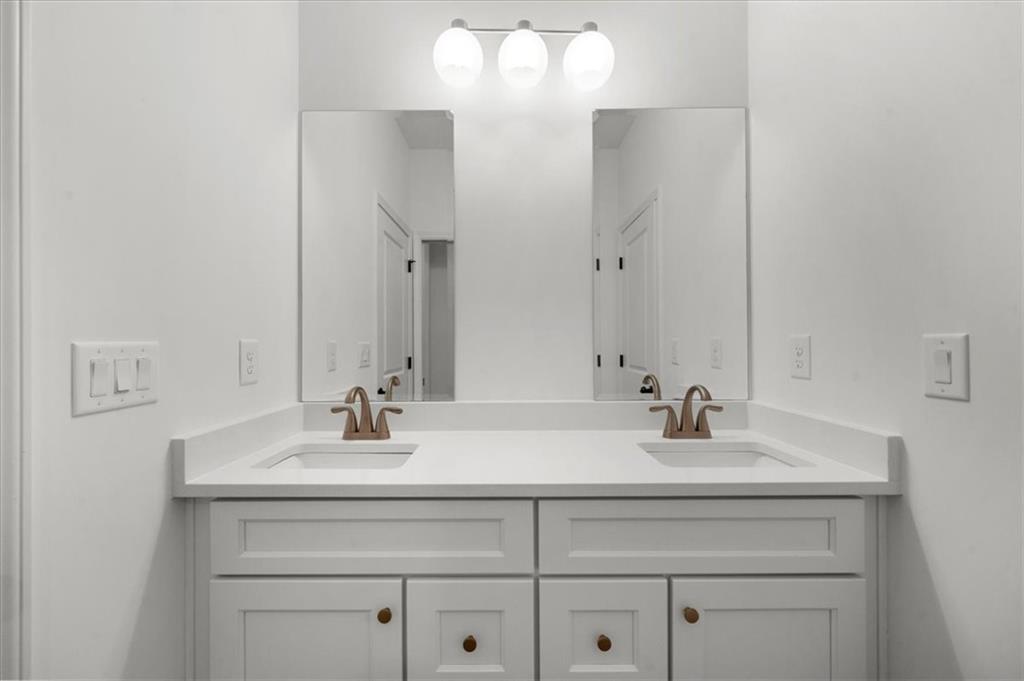 504 Level Creek Road Sugar Hill, GA 30518 - Photo 32 of 54 a bathroom with a sink and a mirror