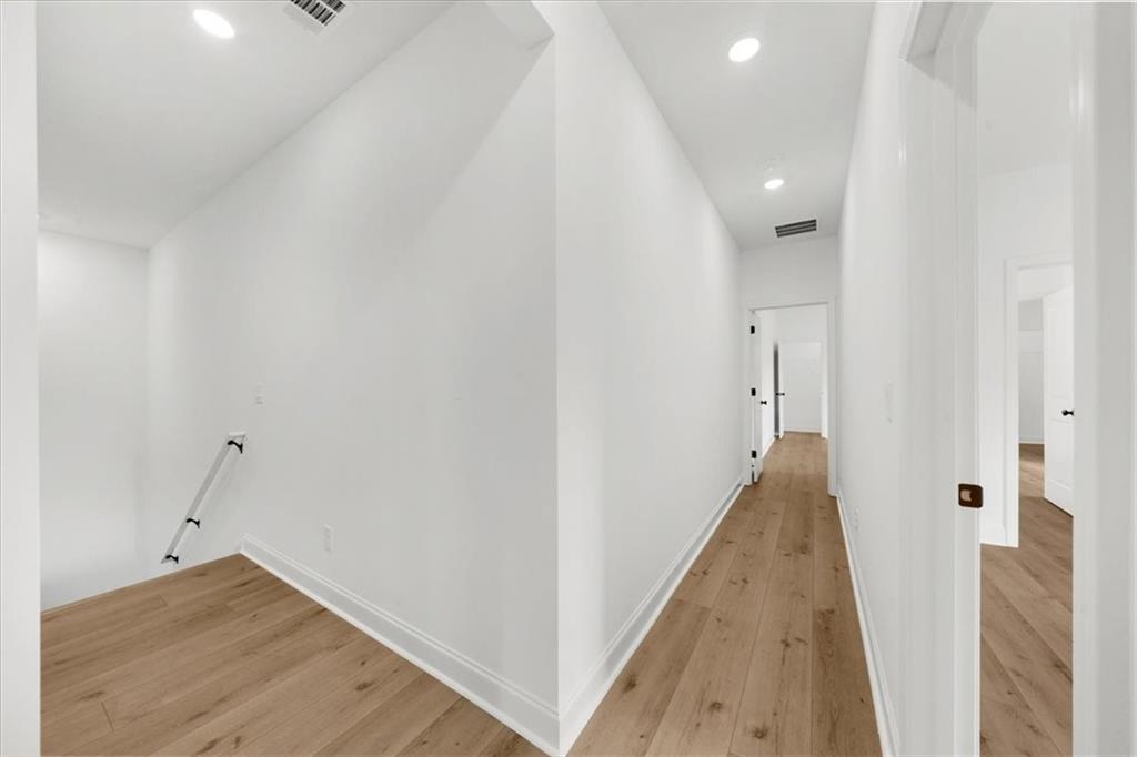 504 Level Creek Road Sugar Hill, GA 30518 - Photo 34 of 54 a view of a hallway with wooden floor and staircase