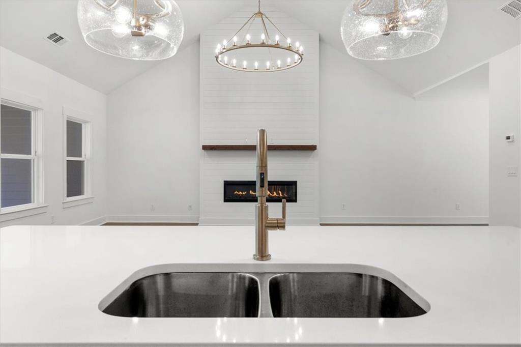 504 Level Creek Road Sugar Hill, GA 30518 - Photo 10 of 54 a kitchen with a sink a chandelier and bathtub