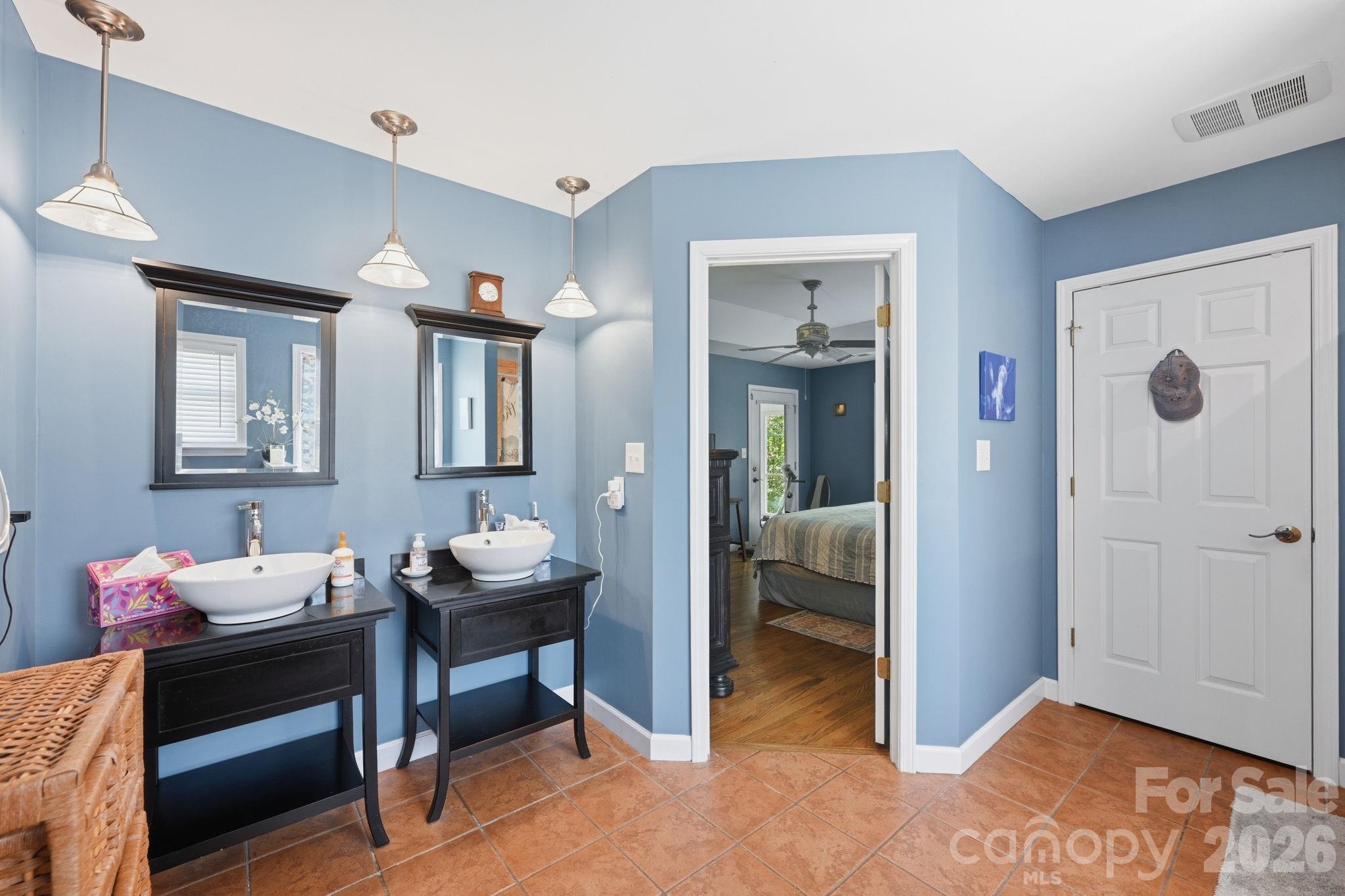 145 Upper Spencer Mountain Road Stanley, NC 28164 - Photo 22 of 29 a en suite bathroom with a double vanity sink and a mirror