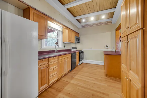 a kitchen with stainless steel appliances granite countertop a sink a stove and a refrigerator