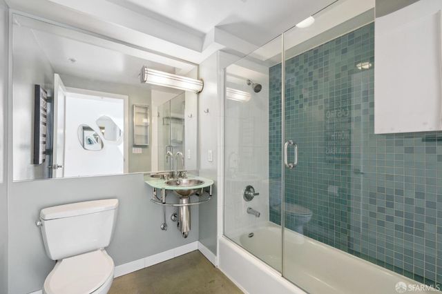 a bathroom with a toilet a sink and bathtub