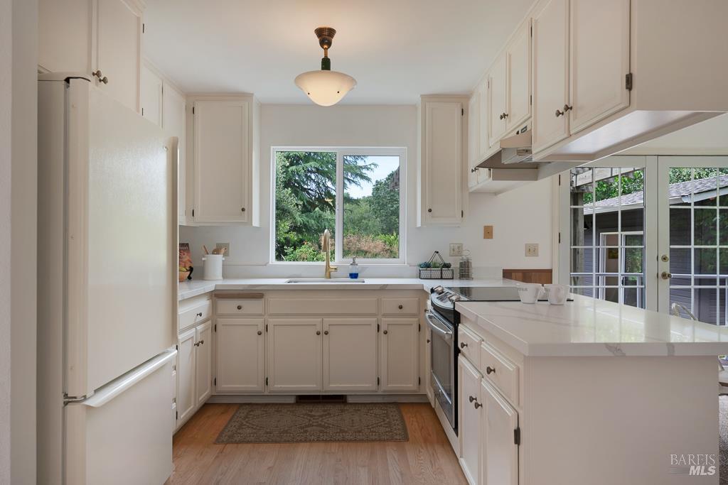 4542 Thomas Road Sebastopol, CA 95472 - Photo 14 of 60 a kitchen with a sink stove and cabinets