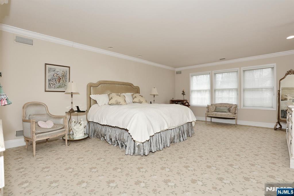 108 Demarest Lane Montvale, NJ 07645 - Photo 11 of 17 a spacious bedroom with a bed a table and large window
