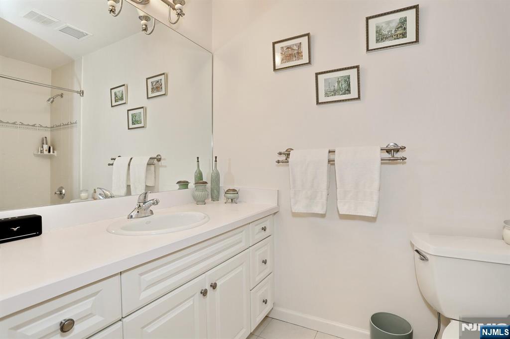 108 Demarest Lane Montvale, NJ 07645 - Photo 15 of 17 a bathroom with a sink a toilet and a mirror