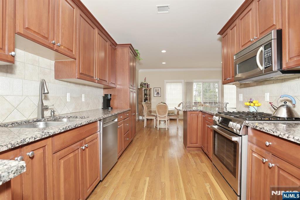 108 Demarest Lane Montvale, NJ 07645 - Photo 4 of 17 a kitchen with stainless steel appliances granite countertop lots of counter top space a stove and a wooden floors