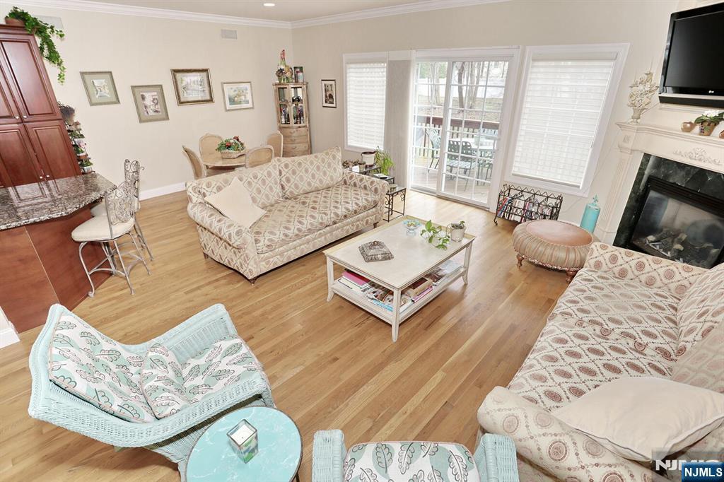 108 Demarest Lane Montvale, NJ 07645 - Photo 7 of 17 a living room with furniture a flat screen tv and a large window