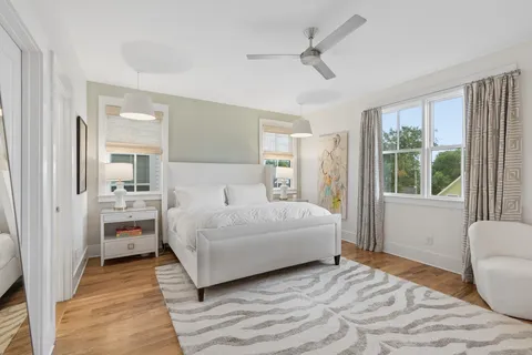 a bedroom with a large bed and a chandelier