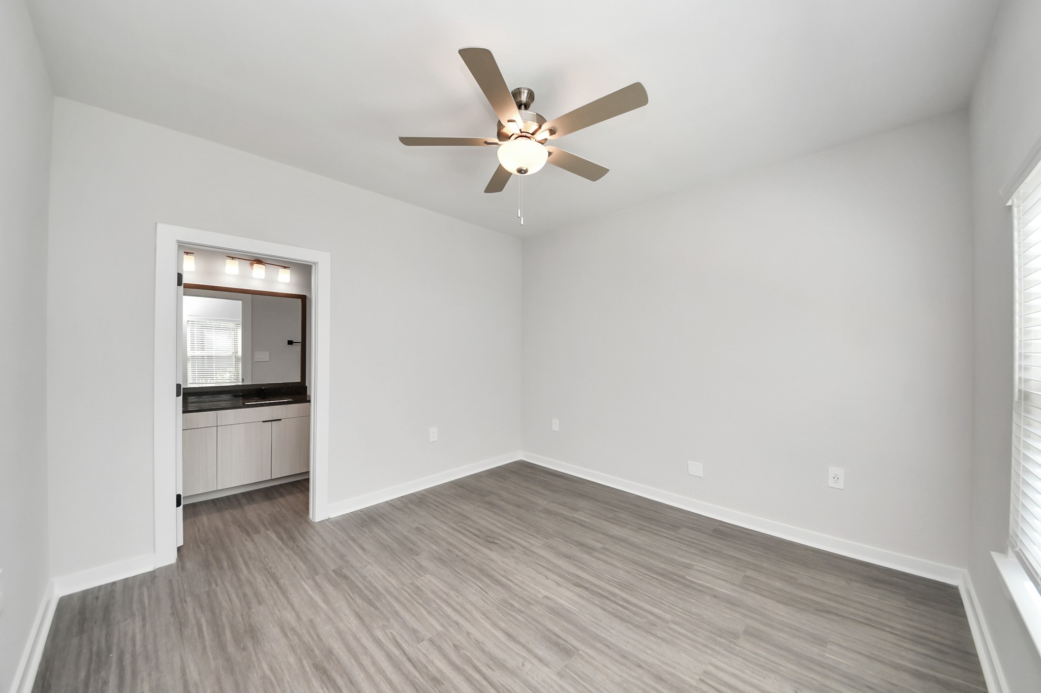 7711 Longmire Road, Unit 5 Conroe, TX 77304 - Photo 11 of 48 Primary Suite offers walk-closet,bath w/dual vanities&lux tub/shower.