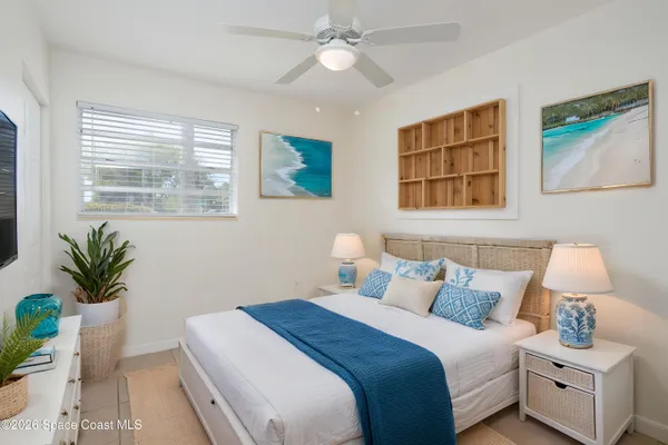 a bedroom with a bed and a potted plant