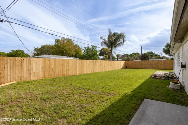 a view of yard with swimming pool and green space