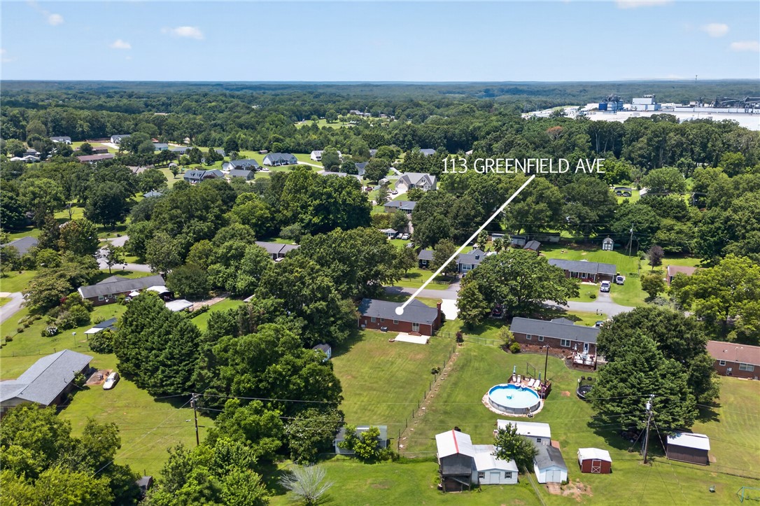 113 Greenfield Avenue Pendleton, SC 29670 - Photo 34 of 40 An aerial perspective reveals a private above ground pool nestled within a verdant, expansive yard.