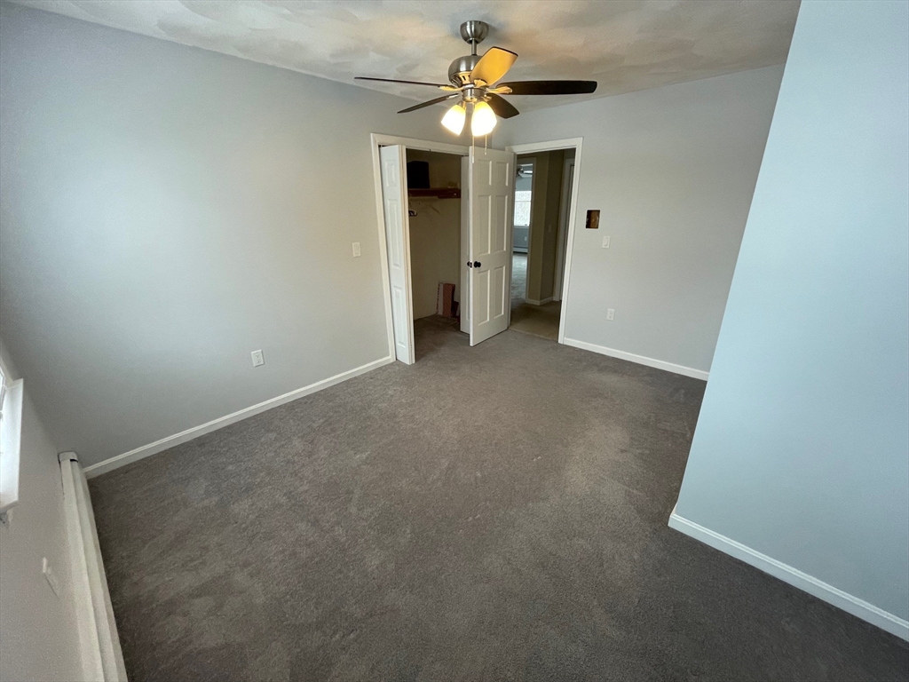 4 Indiana Avenue, Unit 4 Woburn, MA 01801 - Photo 14 of 26 an empty room with a ceiling fan and a window