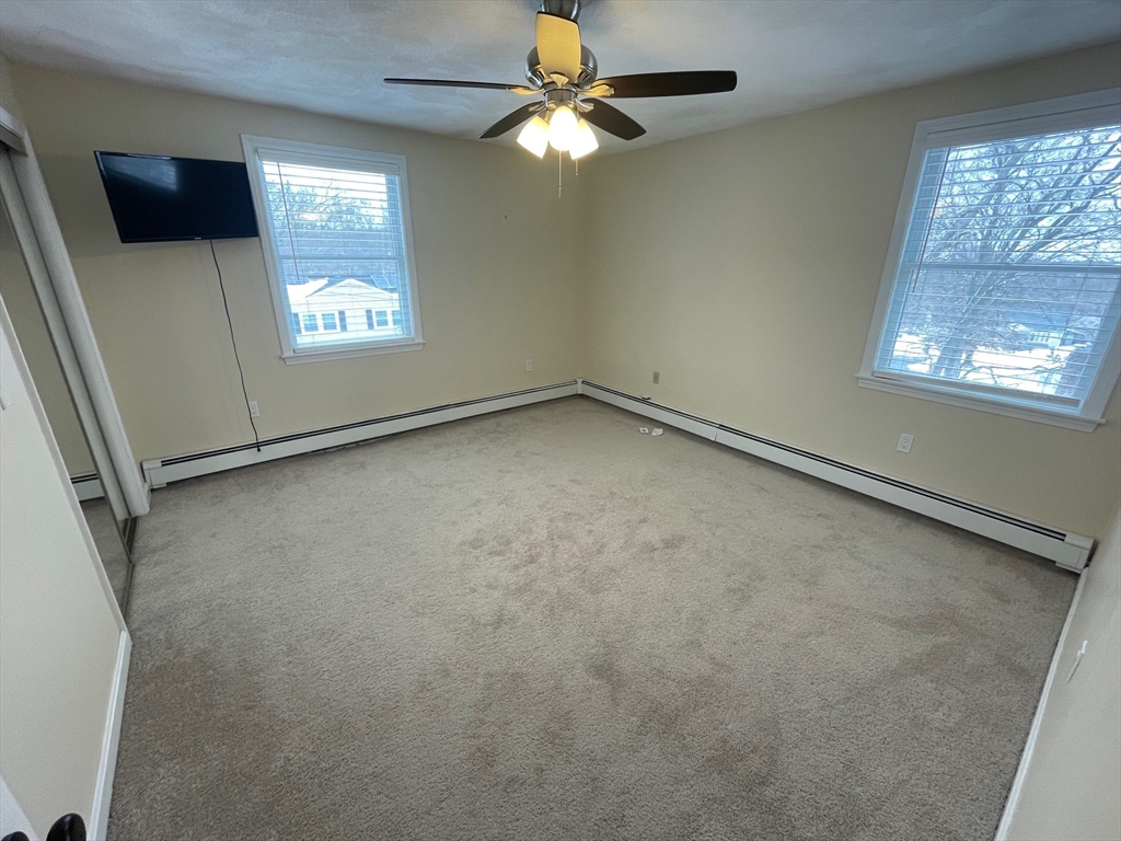 4 Indiana Avenue, Unit 4 Woburn, MA 01801 - Photo 15 of 26 en empty room with windows and fan