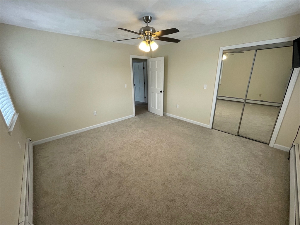 4 Indiana Avenue, Unit 4 Woburn, MA 01801 - Photo 16 of 26 an empty room with fan and entrance
