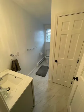 an empty room with windows and chandelier fan