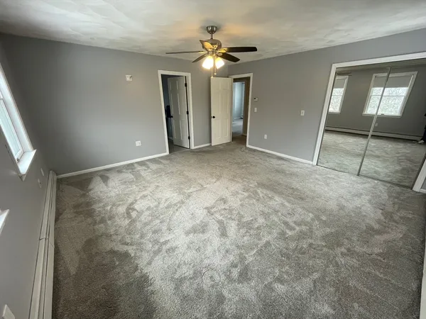 a spacious bathroom with double vanity and a mirror