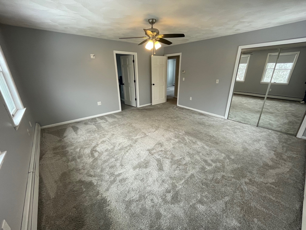 4 Indiana Avenue, Unit 4 Woburn, MA 01801 - Photo 20 of 26 an empty room with a ceiling fan and bathroom view