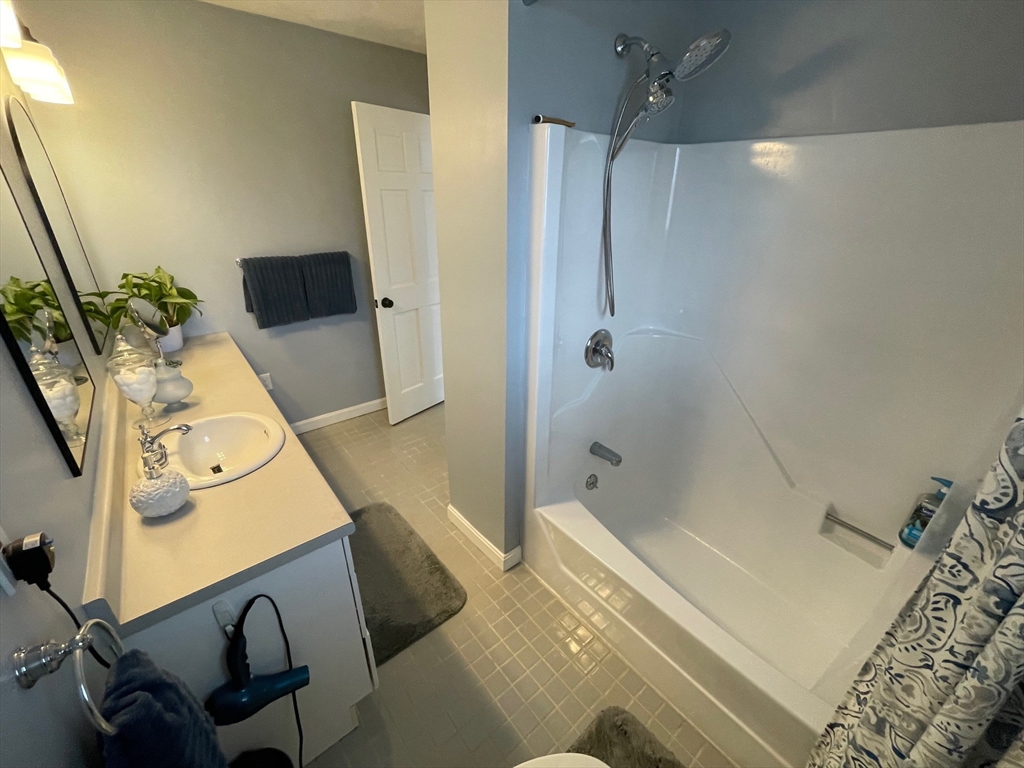 4 Indiana Avenue, Unit 4 Woburn, MA 01801 - Photo 22 of 26 a bedroom with a bed and a flat screen tv