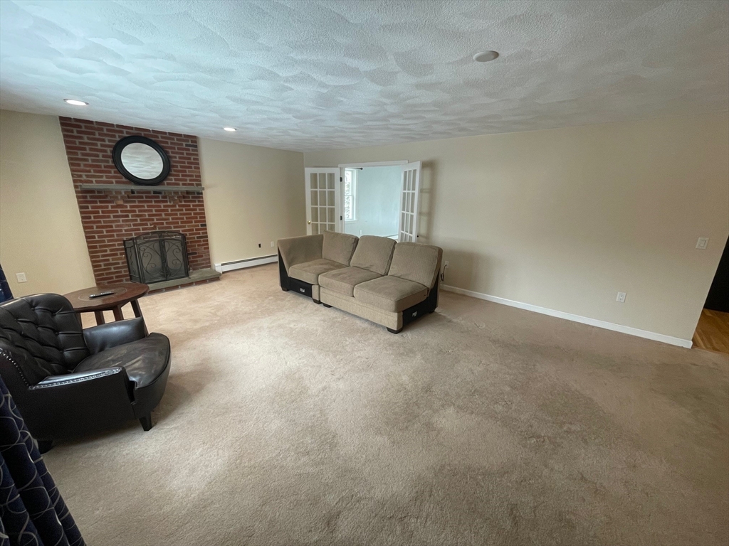 4 Indiana Avenue, Unit 4 Woburn, MA 01801 - Photo 3 of 26 a living room with furniture and a fireplace