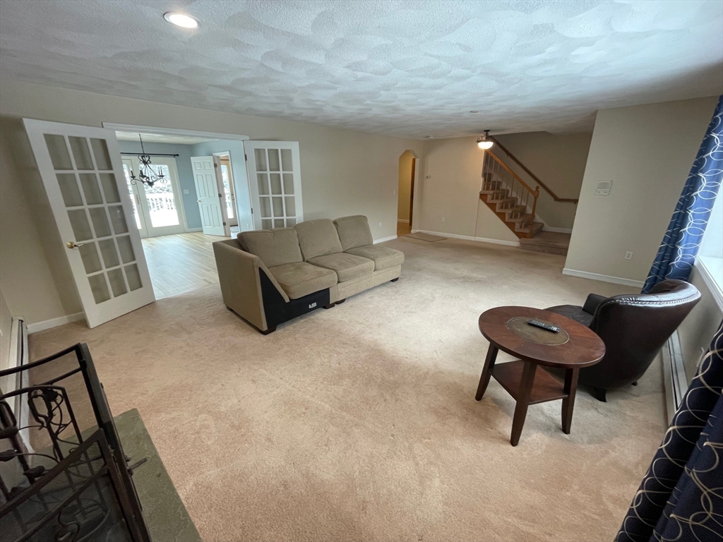 4 Indiana Avenue, Unit 4 Woburn, MA 01801 - Photo 4 of 26 a living room with furniture and a rug