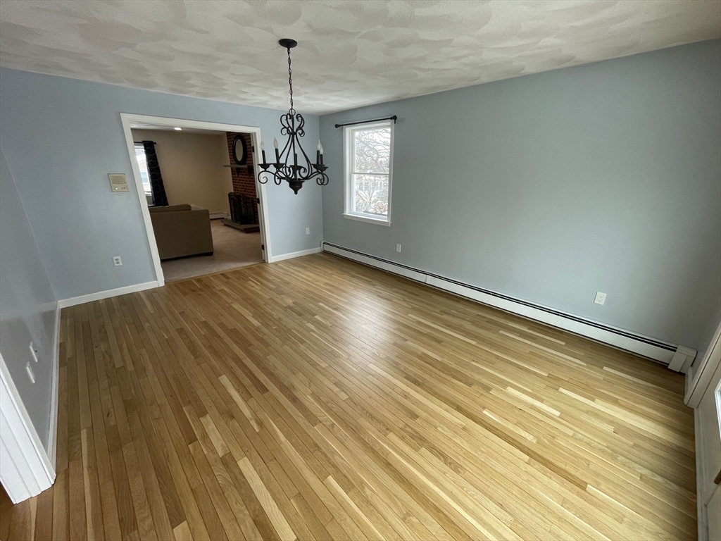 4 Indiana Avenue, Unit 4 Woburn, MA 01801 - Photo 8 of 26 a view of a livingroom with a chandelier