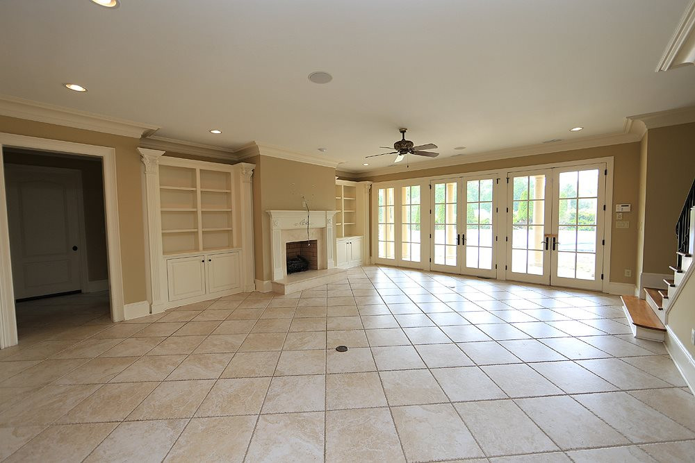 915 Ennis Road Angier, NC 27501 - Photo 20 of 30 Large finished basement, fireplace, full bath and wall of french doors views the pool and patio-fully fenced backyard. Several amazing storage options here! basement