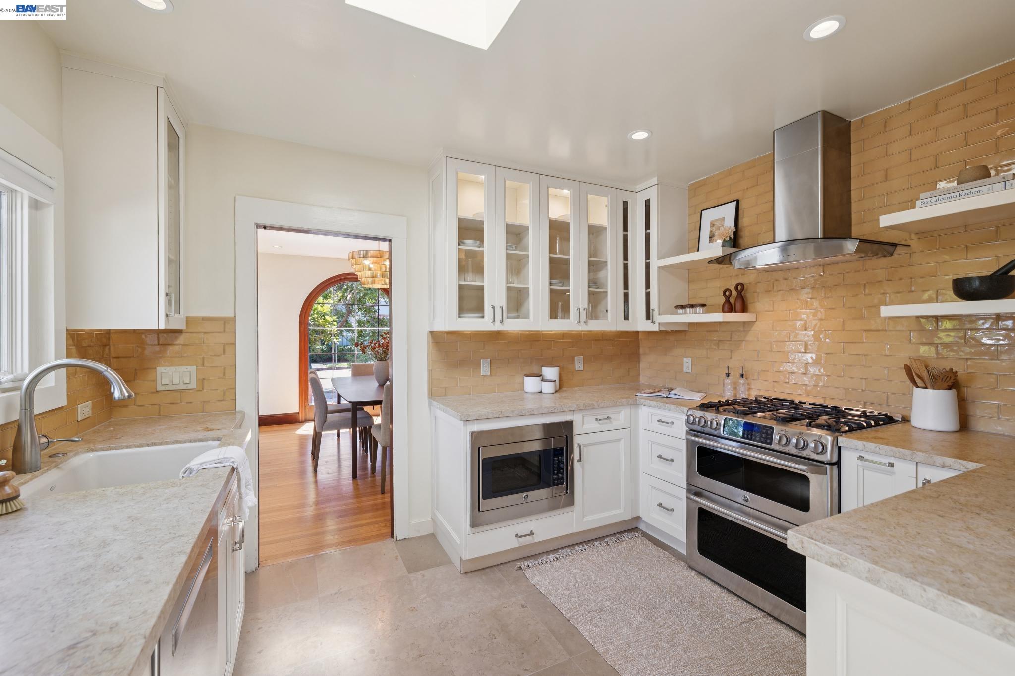 1635 High Street Alameda, CA 94501 - Photo 17 of 56 a kitchen with stainless steel appliances granite countertop a stove a sink and a microwave