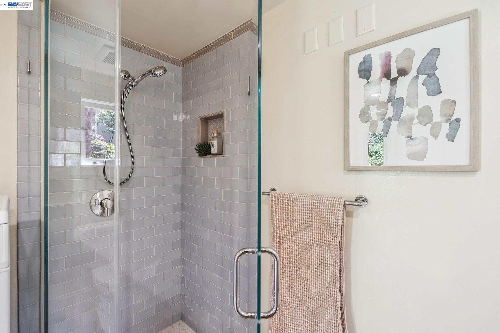 1635 High Street Alameda, CA 94501 - Photo 29 of 56 a bathroom with a glass shower door