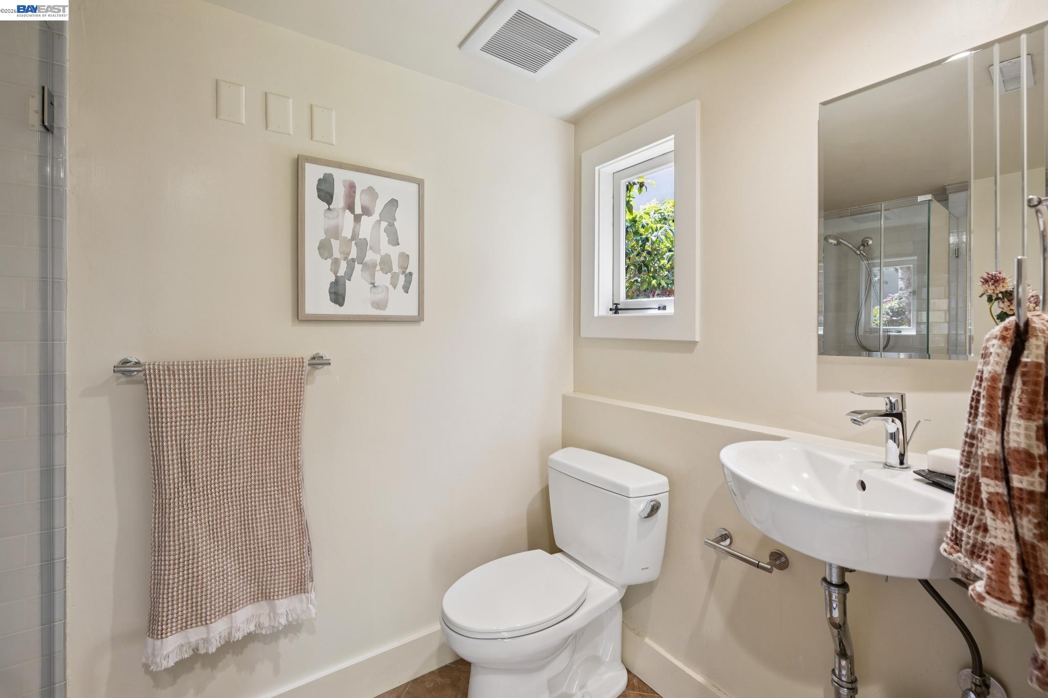 1635 High Street Alameda, CA 94501 - Photo 31 of 56 a bathroom with a toilet a sink and a mirror